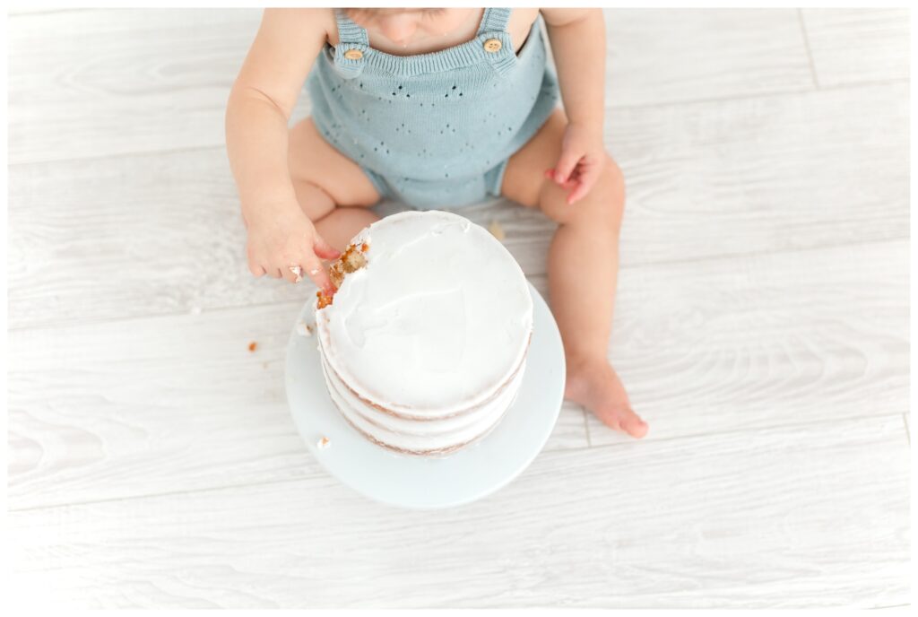 Up close photo of a baby playing with a cake by DC Baby Photographer