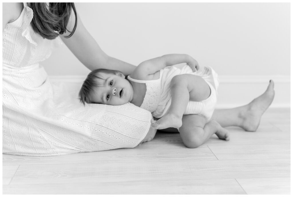 A baby cuddling in her moms lap by DC Baby Photographer