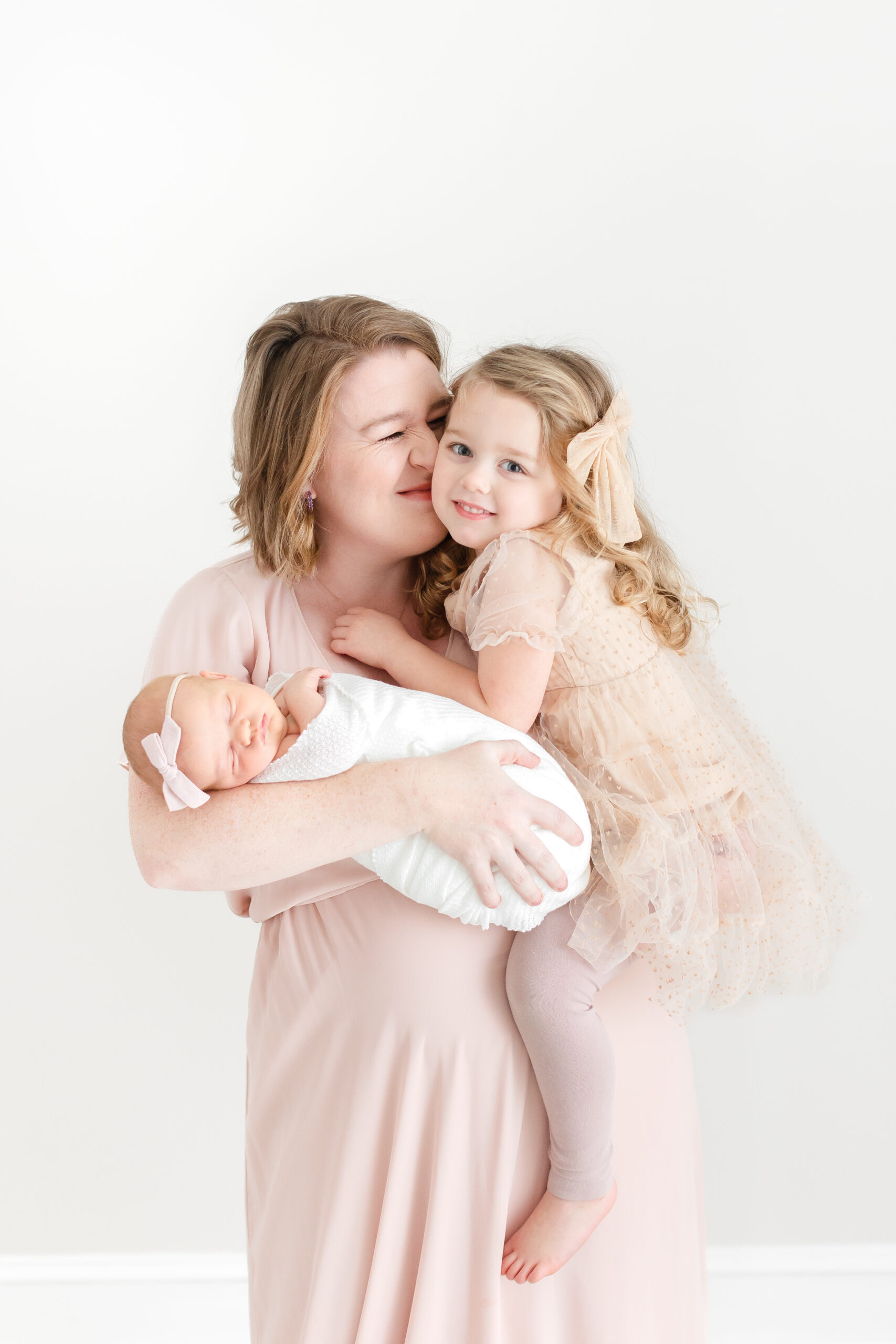 A photo of a mother with her two girls by Washington DC Newborn Photographer
